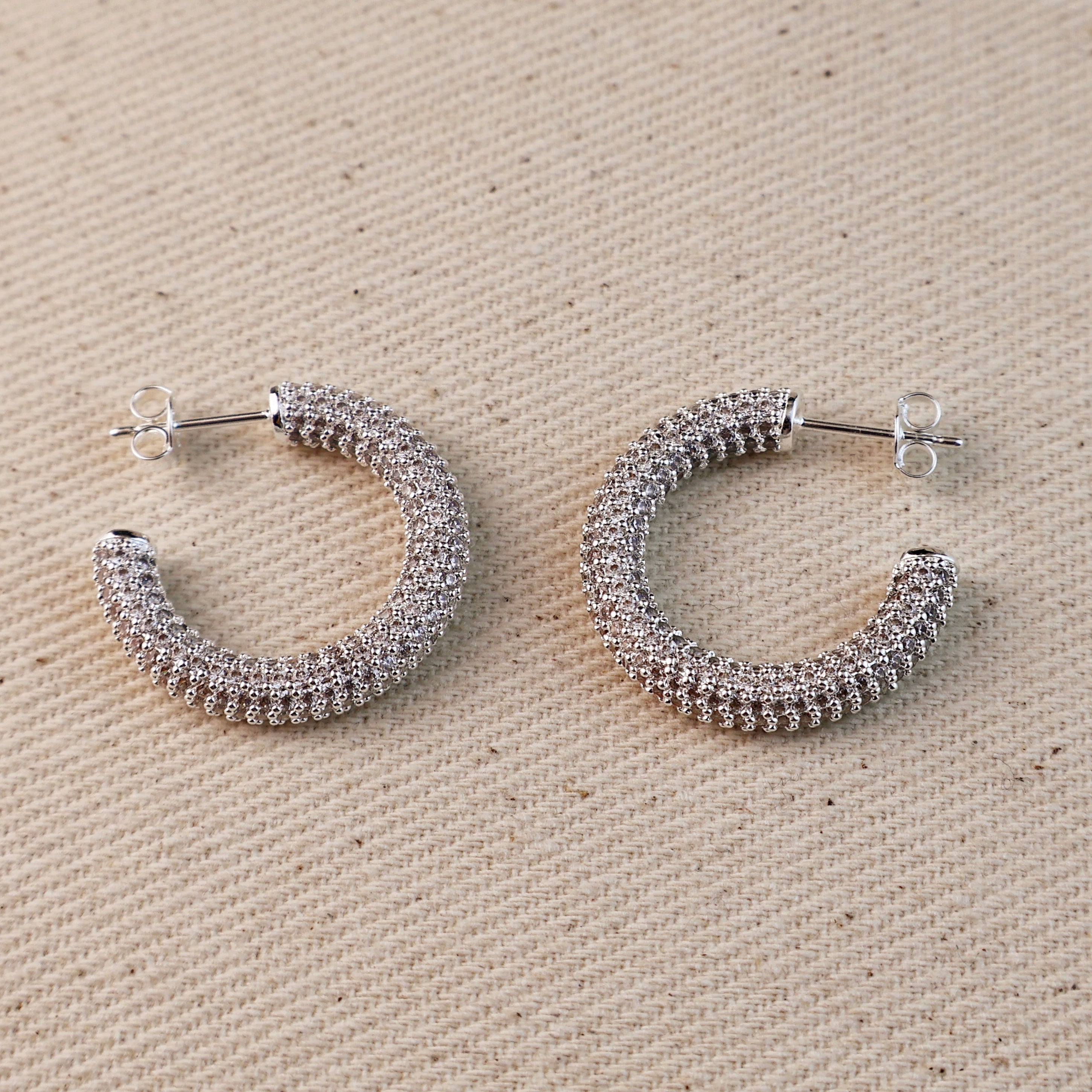 C-Shaped Iced Out Earrings with Micro CZ Stones – Luxury Statement Hoops.