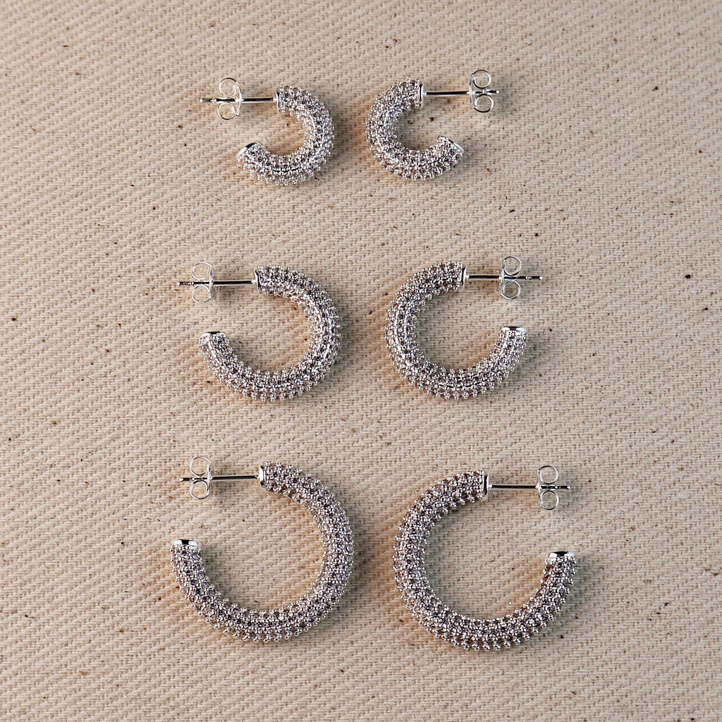 C-Shaped Iced Out Earrings with Micro CZ Stones – Luxury Statement Hoops.