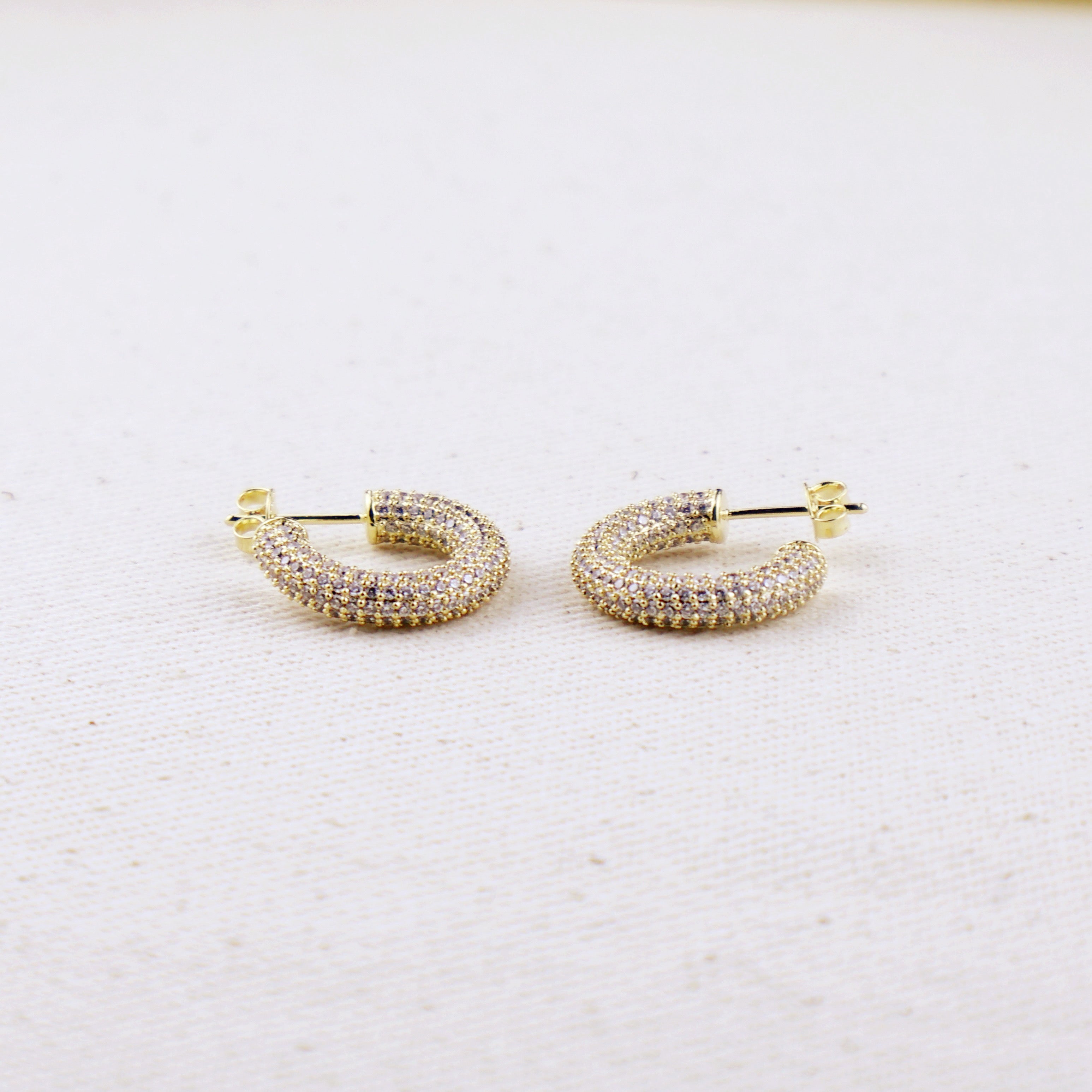 C-Shaped Iced Out Earrings with Micro CZ Stones – Luxury Statement Hoops.