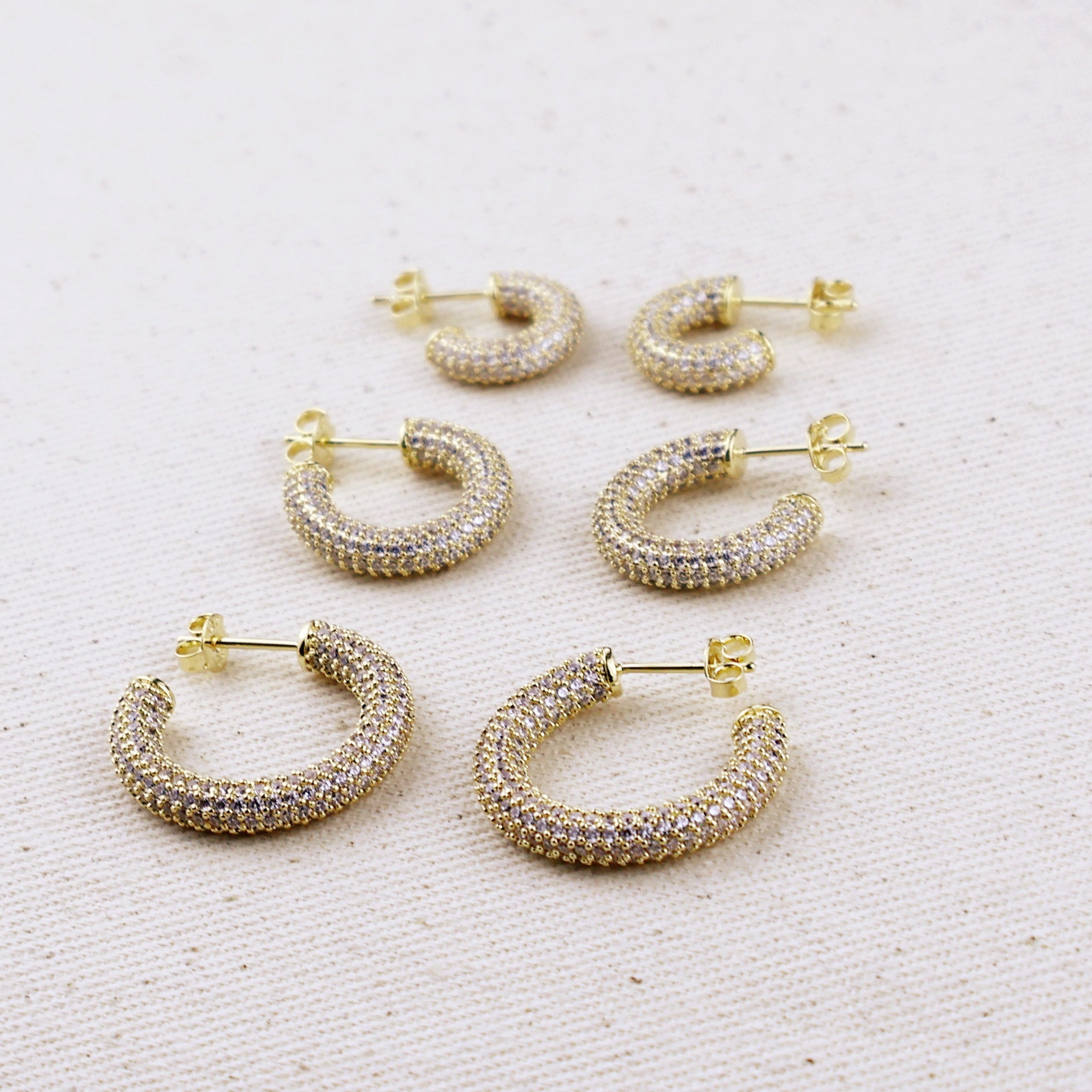 C-Shaped Iced Out Earrings with Micro CZ Stones – Luxury Statement Hoops.